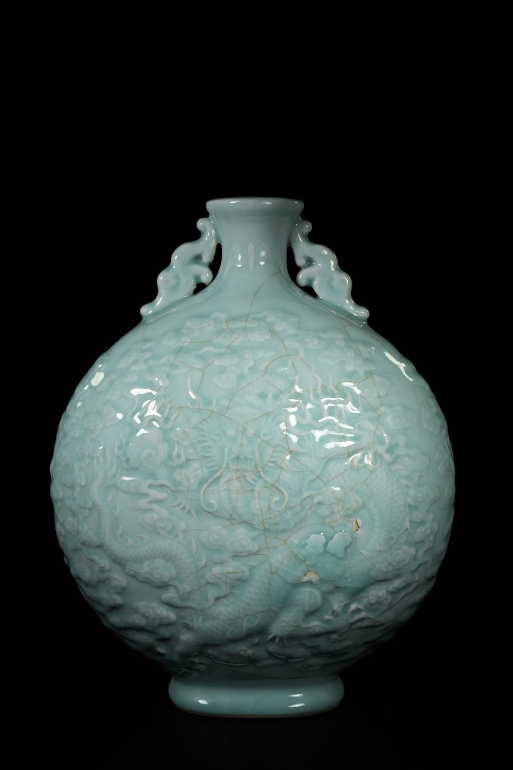 Lot 275: A CHINESE CELADON PORCELAIN MOONFLASK WITH RAISED DRAGON MOTIF, QIANLONG MARK.