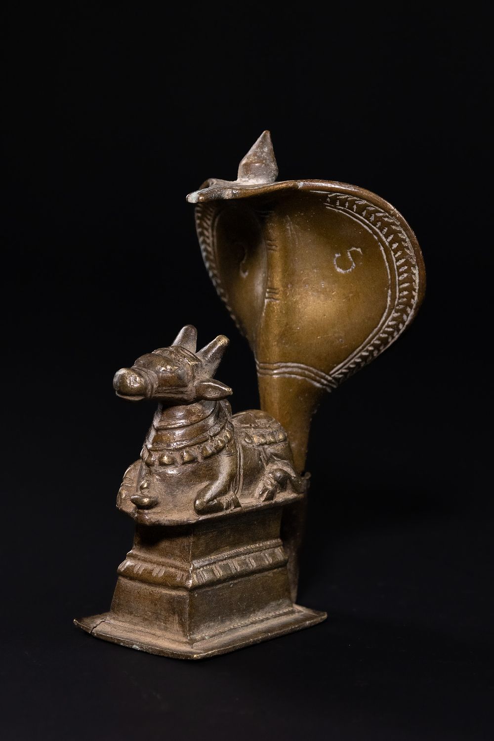 Lot 312: A DECCAN BRONZE NAGA-NANDI SHRINE SCULPTURE, 19TH CENTURY.