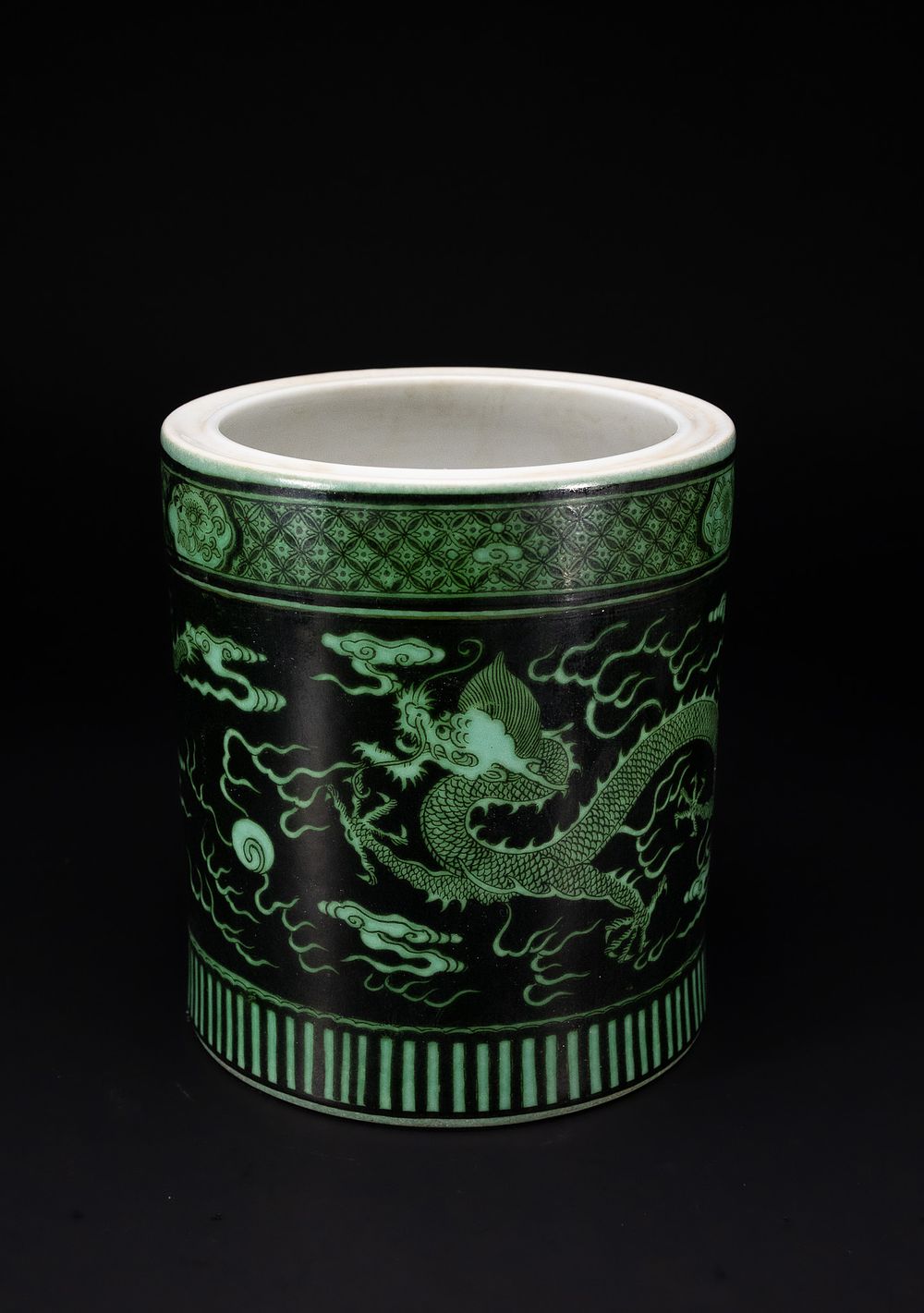 Lot 328: A CHINESE GREEN-ENAMELLED BLACK-GROUND DRAGON BRUSH POT, BITONG.
