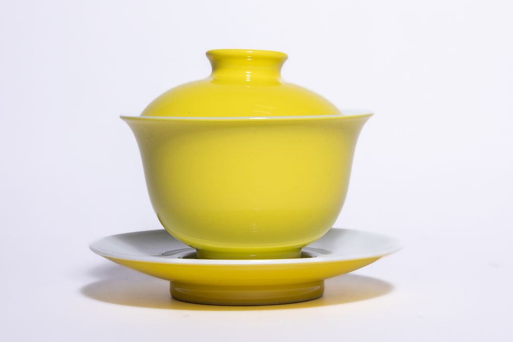 Lot 341: A CHINESE MONOCHROME YELLOW-GLAZED PORCELAIN GAIWAN AND SAUCER, YONGZHENG MARK.