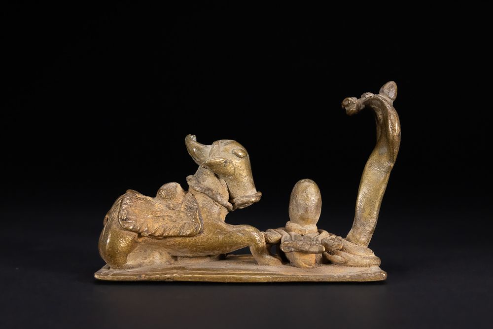 Lot 344: A WESTERN INDIAN FOLK STYLE BRONZE SHIVA DEVOTIONAL GROUP WITH NANDI AND NAGA, LATE 19TH/EARLY 20TH CENTURY.