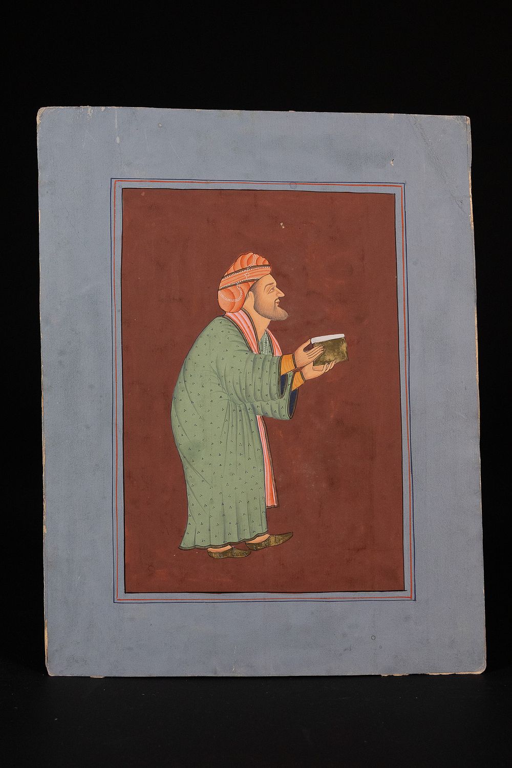 Lot 345: PROVINCIAL MUGHAL SCHOOL, 18TH/19TH CENTURY, 'PORTRAIT OF A NOBLEMAN HOLDING A BOOK'.