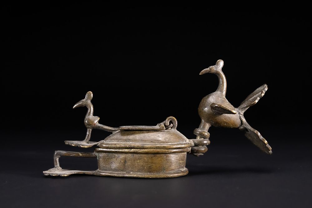 Lot 346: AN INDIAN BRONZE PEACOCK KOHL OR KUMKUM CONTAINER ANJANDANI, DECCAN REGION, LATE 19TH CENTURY / EARLY 20TH CENTURY.