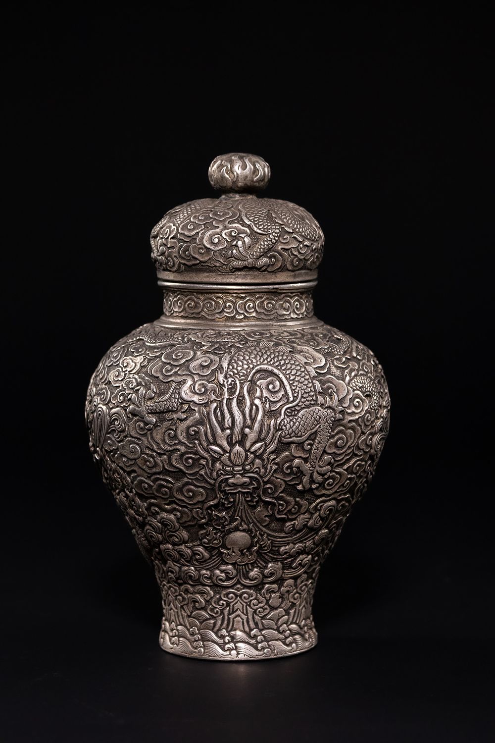 Lot 349: A CHINESE WHITE METAL LIDDED DRAGON JAR.