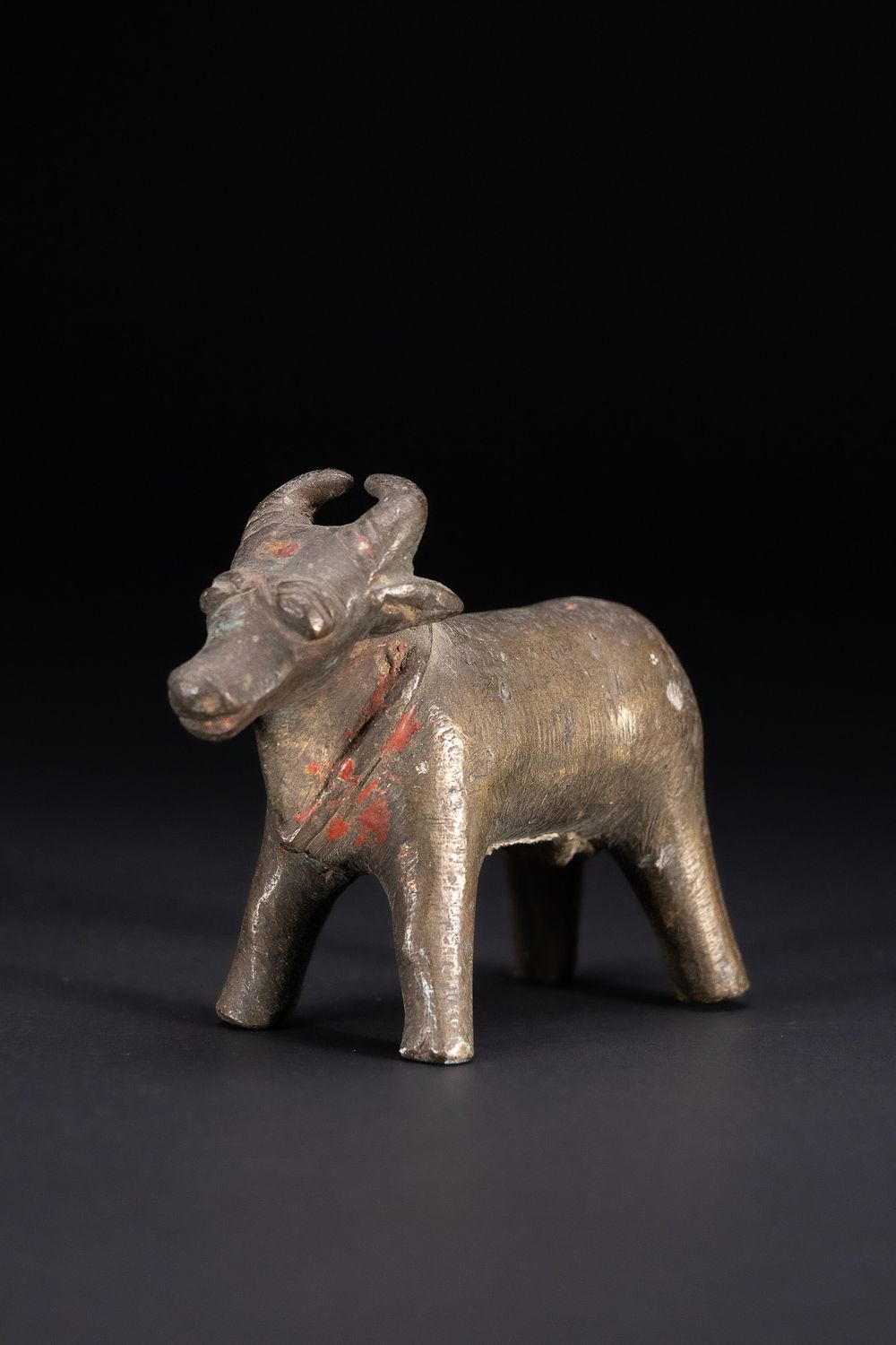 Lot 357: AN INDIAN FOLK BRONZE FIGURE OF NANDI OR A BHUTA BULL.