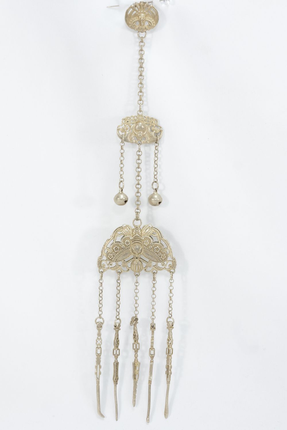 Lot 365: A CHINESE-TIBETAN WHITE METAL HAIR ORNAMENT WITH PENDANT CHAINS.