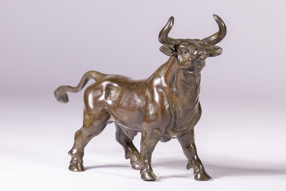 Lot 377: A JAPANESE BRONZE OKIMONO OF A CHARGING BULL.