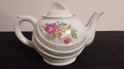 Vintage Lamode Fine China Teapot. Delicately crafted, its porcelain surface showcases a tasteful 