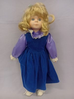 Blond Blue Eye Blue Dress Porcelain Doll. A delicate porcelain doll with fair, smooth skin 