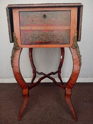 Vintage Victorian Drop Leaf Side Table. This side table features ornate brass embellishments.