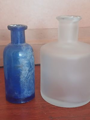 2 Decorative Bottles. Antique blue glass and a modern frosted glass