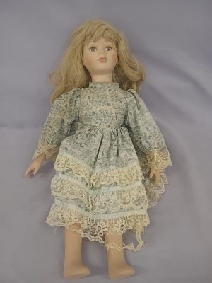 Symphony Annie Porcelain Doll. A charming collectible with a porcelain head, hands, and feet. 