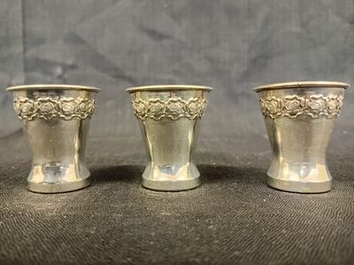 Three 810 Silver Kiddush Cups. A set of three 810 silver Kiddush cups, each featuring an elegant 