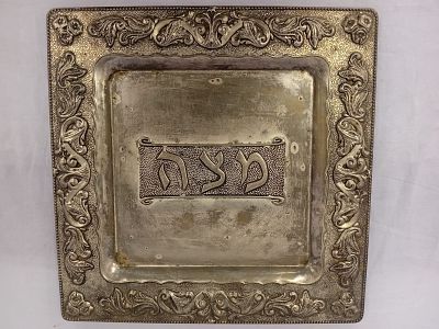 Silver-Plated Matzah Tray. A silver-plated matzah tray features a sleek and understated design 
