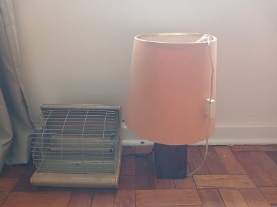 Vintage Heater & Sleeper Wood Table Lamp. This lot features a vintage heater alongside a unique 