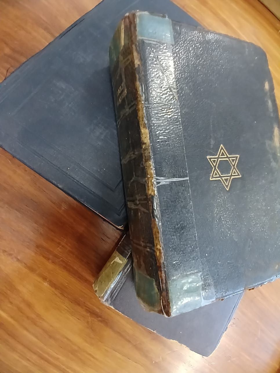 Vintage Siddurim and a Machzor. A bundle of three vintage prayer books, consisting of two daily 