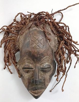 Vintage Mwana Pwo Chokwe Mask. A captivating Chokwe Mask, skillfully carved from wood, comes to 