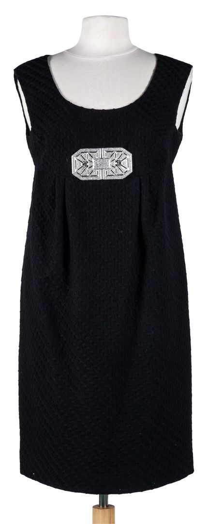 VALENTINO. A black wool dress with Art Deco brooch. Size 42 700 - 900 €