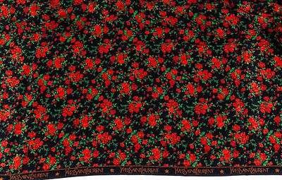 YVES SAINT LAURENT. A printed fabric with floral motifs in red, green, and black 144 x 203 cm 