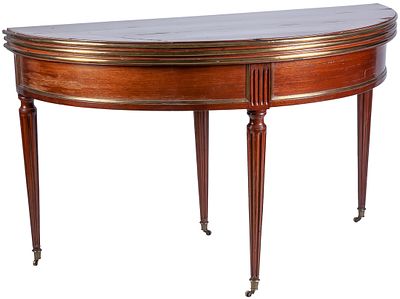 A mahogany and gilt-brass demi-lune table, convertible into a circular table with wheels on the 