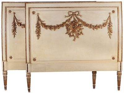 A pair of Louis XVI style polychrome-painted and parcel-gilt beds decorated with ribbons and 