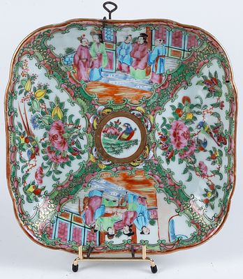 A Cantonese porcelain saucer decorated with courtly scenes and flowers in cartouches 25 x 25 cm 