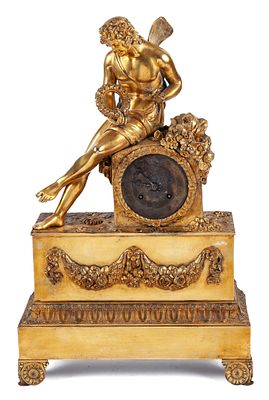 A French gilt-bronze mantel clock surmounted by a winged male allegory. Restoration period 