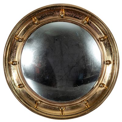 A convex gilt-brass mirror decorated with balls 43 cm 150 - 200 €
