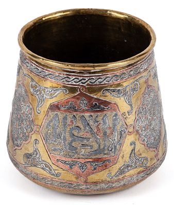 A 19th Century Turkish brass and copper vessel with Arabic character decoration in cartridges 