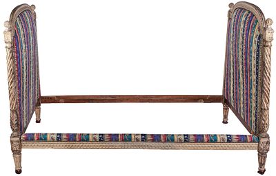 A French Louis XVI white-lacquered carved wood bed, late 18th Century. Retains original wheels 