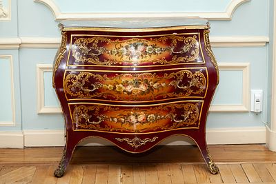 A French Louis XV style lacquered bomb&eacute; commode with floral decoration and 