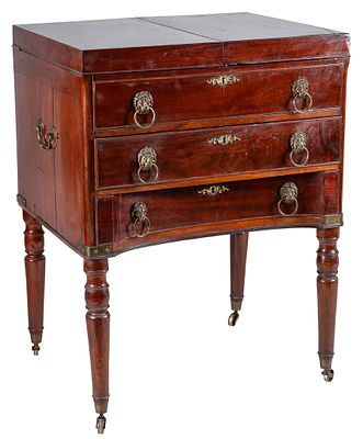 An English Regency mahogany desk with drawers and turned legs on casters, early 19th Century 89 
