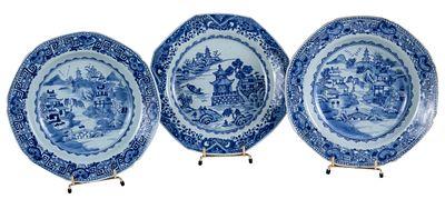 A set of three East India Company plates with blue and white decoration. One plate with a chip 