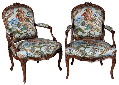 A pair of Louis XV style French carved wood and "&agrave; la reine" back armchairs with 