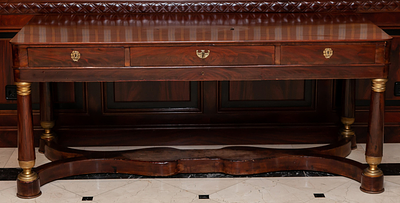 A French gilt bronze-mounted mahogany table. Empire period, early 19th Century 68 x 74 x 178 cm 