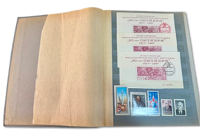 Soviet Union stamp album in gray with dozens of stamps from the 1960s-1970s. Most of the stamps 