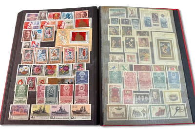 Soviet Union stamp album in red with hundreds of stamps from the 1960s-1970s. Unsigned stamps 