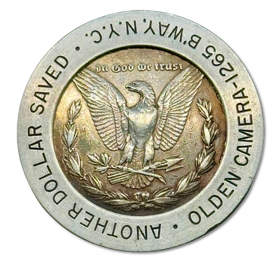 ארצות הברית - מטבע כסף 1 דולר משנת 1880 - "מורגן דולר" ששולב בתוך טבעת מתכת פרסומית של חנות 