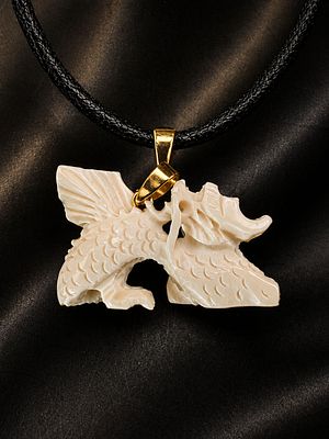 Dragon pendant, intricately hand-carved from a luxurious organic material in a light tone. The 