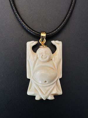 Hand-carved Buddha pendant crafted from a fine organic material, depicting a joyful figure with 