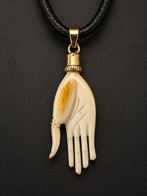 Hand-carved hand-shaped pendant crafted from a fine organic material, featuring delicate 