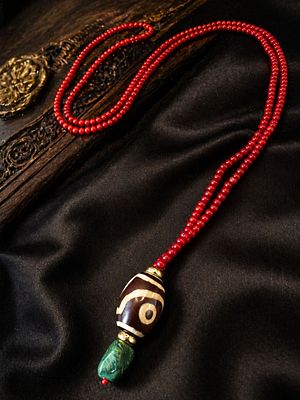 Red Coral Bead Necklace with Painted Stone Bead and Green Pendant
. A refined necklace composed 