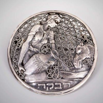 "רבקה" - סיכת כסף סטרלינג וכסף פיליגרן בעיצוב זאב רבן, בצלאל, תחילת המאה ה-20. נושאת כיתוב 