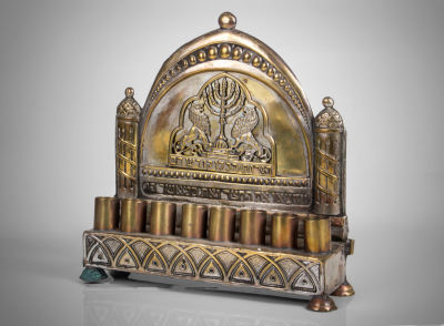 חנוכיית פליז לתלייה, בצלאל, כנראה שנות ה-1940. במקור מצופה כסף. חתומה "בצלאל ירושלם" בלוחיות 