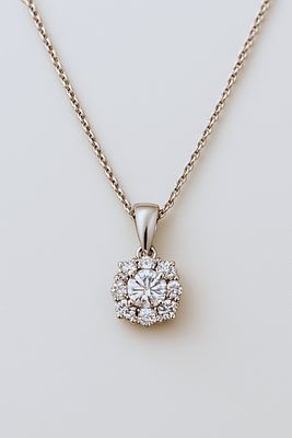 18K gold necklace with a diamond pendant totaling 0.30 carats
. White gold pendant set