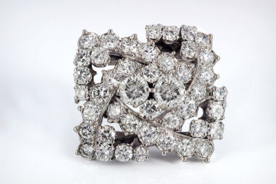 A Diamond and Platinum Brooch. Dimensions Total weight: 11 gr Details A stylized geometric 