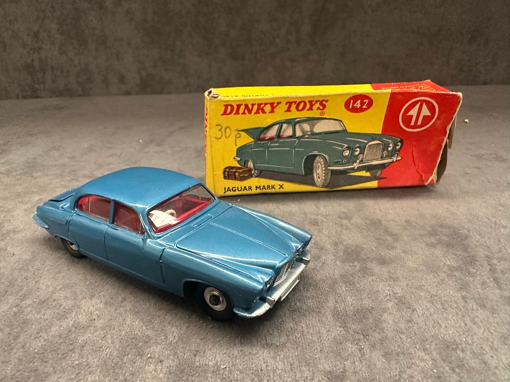 Lot 194: Dinky Toys 142 Jaguar Mark X Blue with Suitcase. Box has slight crushing and missing end tab.