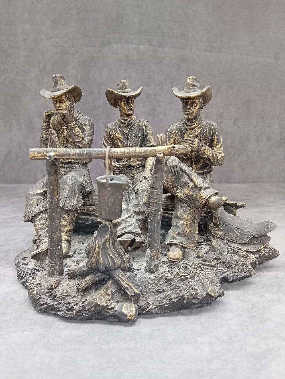 Lot 67: Bronzed resin ornament of three cowboys sitting by...