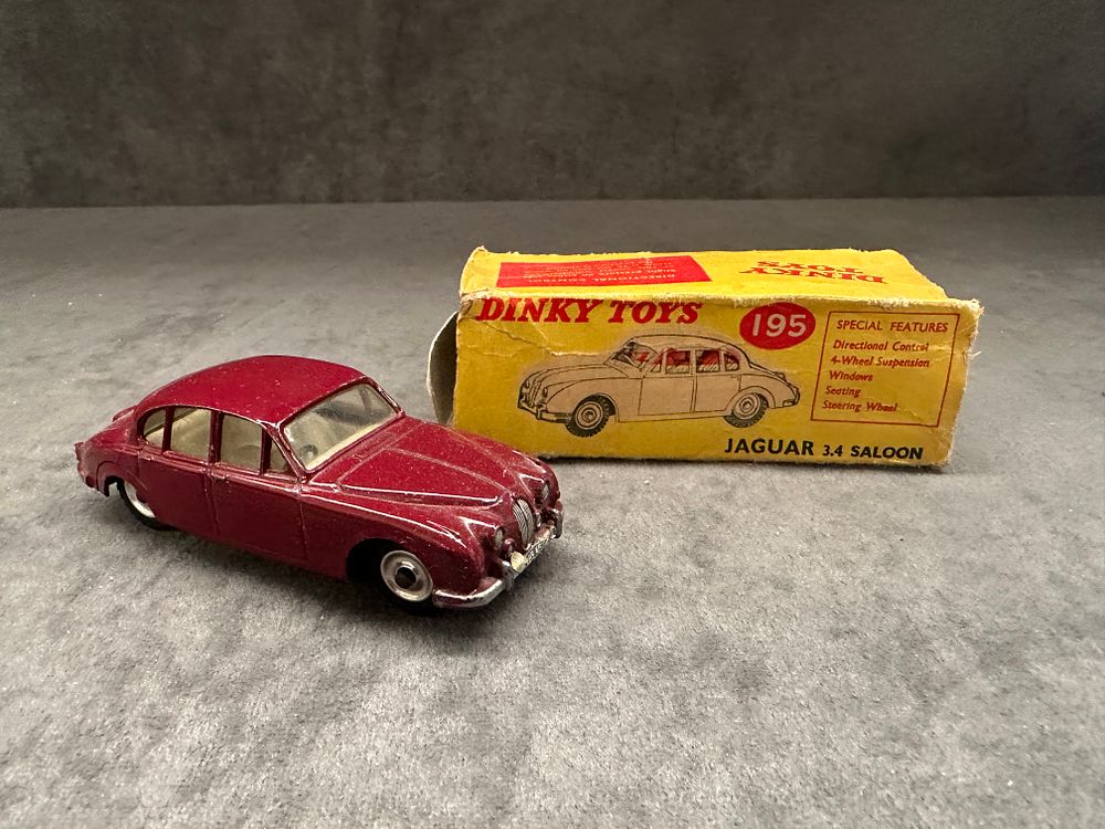 Lot 325: DINKY TOYS 195 JAGUAR 3.4 SALOON MK.II DARK RED BODY WITH CREAM INTERIOR box missing end tab and has slight crushing.