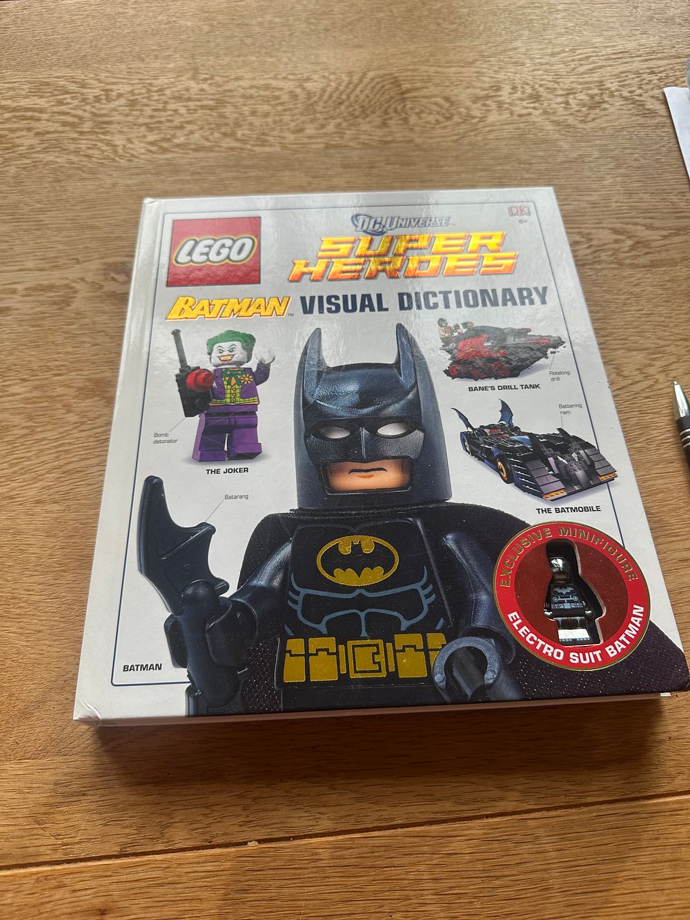 Lot 190: Lego super hero visual dictionary with mini figure.